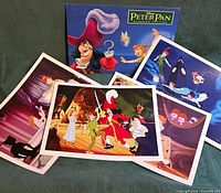 Set of four lithographs spread out with presentation folder behind