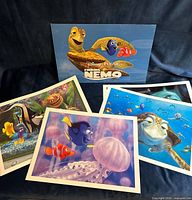 Folder cover with turtle and Nemo, four lithographs displayed
