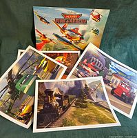 Group view of folder and four lithograph prints