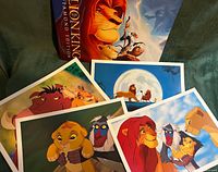 All four lithographs and presentation folder displayed