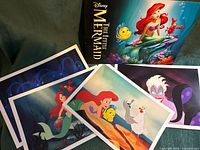 All four lithographs and presentation folder displayed