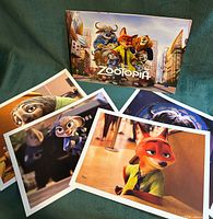 All four lithographs and presentation folder displayed together