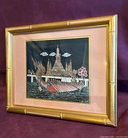 Front view of framed Thai silk artwork in gilt bamboo frame