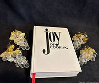 Front view of cookbook with four lucite grape clusters