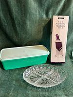 Overall view of Tupperware container, Epicure mandoline box, glass tray