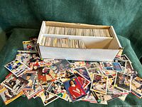 Open long box showing two rows of NHL trading cards plus loose cards spread out in front