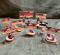 Group shot of all eight Lemax Village Collection blister packs