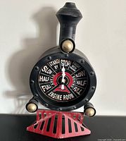 Front view of locomotive telegraph style clock showing dial and design details