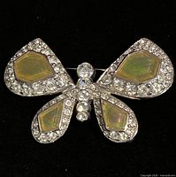 Front view of Nina Ricci butterfly brooch showing iridescent panels and crystal pavé