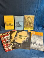 Group shot of all books, guides, magazine and some maps