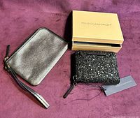 Both leather pieces side by side; Rebecca Minkoff wallet with box, Fossil wristlet visible