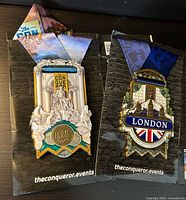 Front view of both Rome and London medals in presentation folders