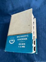Front and spine view of Machinery’s Handbook hardcover showing title panel
