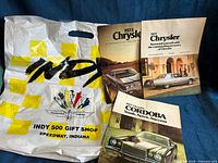 Front view of Indy 500 bag and all three brochures