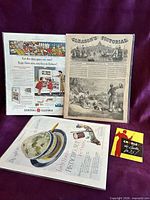 Front view showing three advertisement pages in protective sleeves and Crosley brochure