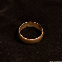 Ring front view showing wide brass-tone band