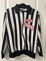 Front view of striped referee jacket displaying patches