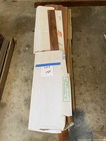 Stack of three boxes containing wood flooring planks