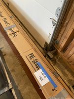 Close view of carton showing PRE-SANDED label and lot tag