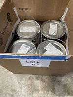 Box containing four one-gallon paint cans