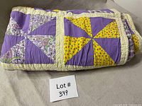 Quilt folded to show front pinwheel design