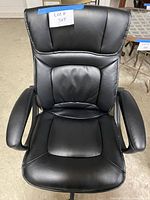 Front view of black faux leather executive office chair showing seat, backrest, and armrests