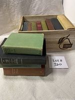 Full lot view—wood crate with 12 books, four stacked in front