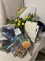 Group shot showing canvas, palette pad, faux florals, fabric and cork bags