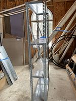 Full view of tall metal shelving unit with five shelves