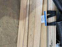 Stack of oak flooring boards showing raw surface and grain