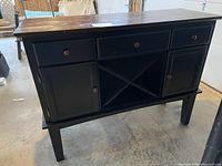 Front view of sideboard showing drawers, doors, wine rack and wear