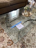 Top view showing rectangular beveled glass top, metal legs and stretcher