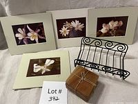 All items arranged: four matted floral photos, iron holder, stack of four wood coasters