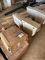 Stacked Gerber branded cardboard boxes and two used toilets nearby