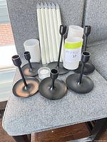 Group of LED candles and black holders on chair