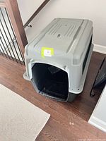 Full view of plastic dog crate front and top