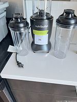 Nutribullet base with cord, two cups, two lids