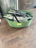 Green bin filled with assorted hangers
