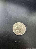 Reverse showing eagle landing on moon with UNITED STATES OF AMERICA and ONE DOLLAR legends