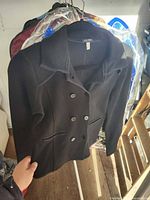 Front view of Armani Jeans black blazer on hanger