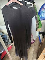 Full front view of black long-sleeve dress on hanger