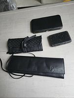 Four items closed: wallet, jewelry roll, card holder, Brinkhaus pouch