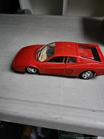 Left side view of red 1:18 scale Ferrari Testarossa model