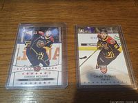 Front view of both Connor McDavid cards in top loaders