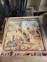 Front view of tapestry showing full design, fringe and border