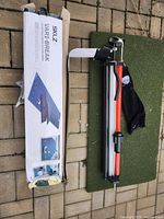 Boxed SKLZ Vari-Break putting green, folded components, clubs, bag, turf mat