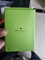 Front of green Kate Spade New York box