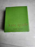 Front of green Kate Spade New York box