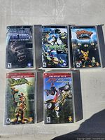 Front covers of five PSP game cases laid out