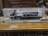 Front view of sealed boxed set showing truck, trailer and car